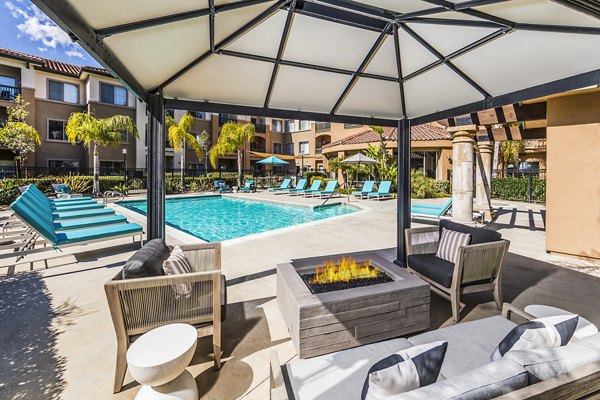 Serene outdoor pool at Overture Rancho Santa Margarita Active Adult Apartments surrounded by lush greenery
