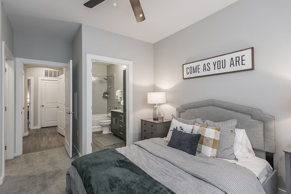 Elegant bedroom with designer decor in Novel Lockwood Glen Apartments, luxury community by Greystar