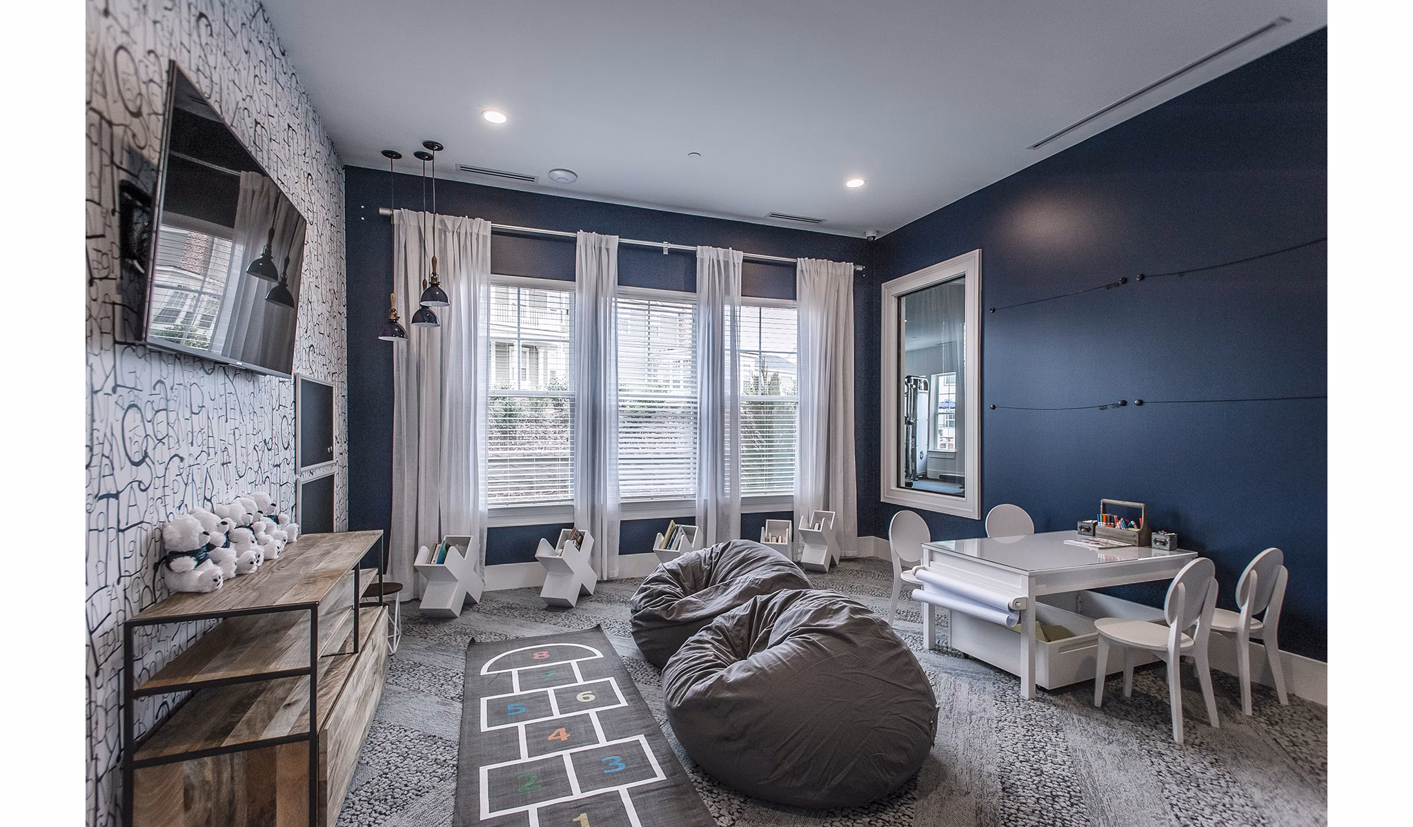 Modern game room with pool table and lounge chairs at Novel Lockwood Glen Apartments