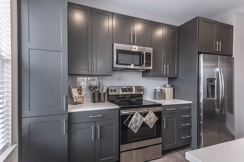 Modern kitchen with stainless steel appliances at Novel Lockwood Glen Apartments, featuring a spacious island and sleek cabinetry for luxury living