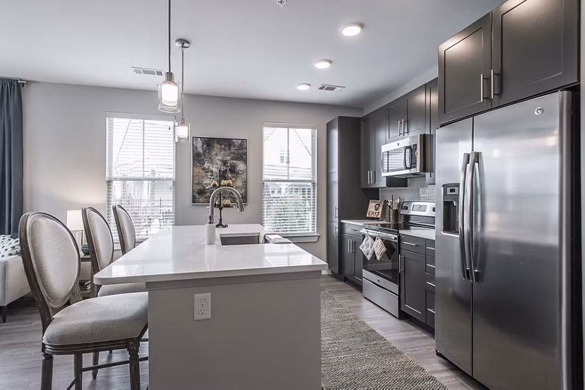 Modern kitchen with stainless steel appliances at Novel Lockwood Glen Apartments in luxury setting