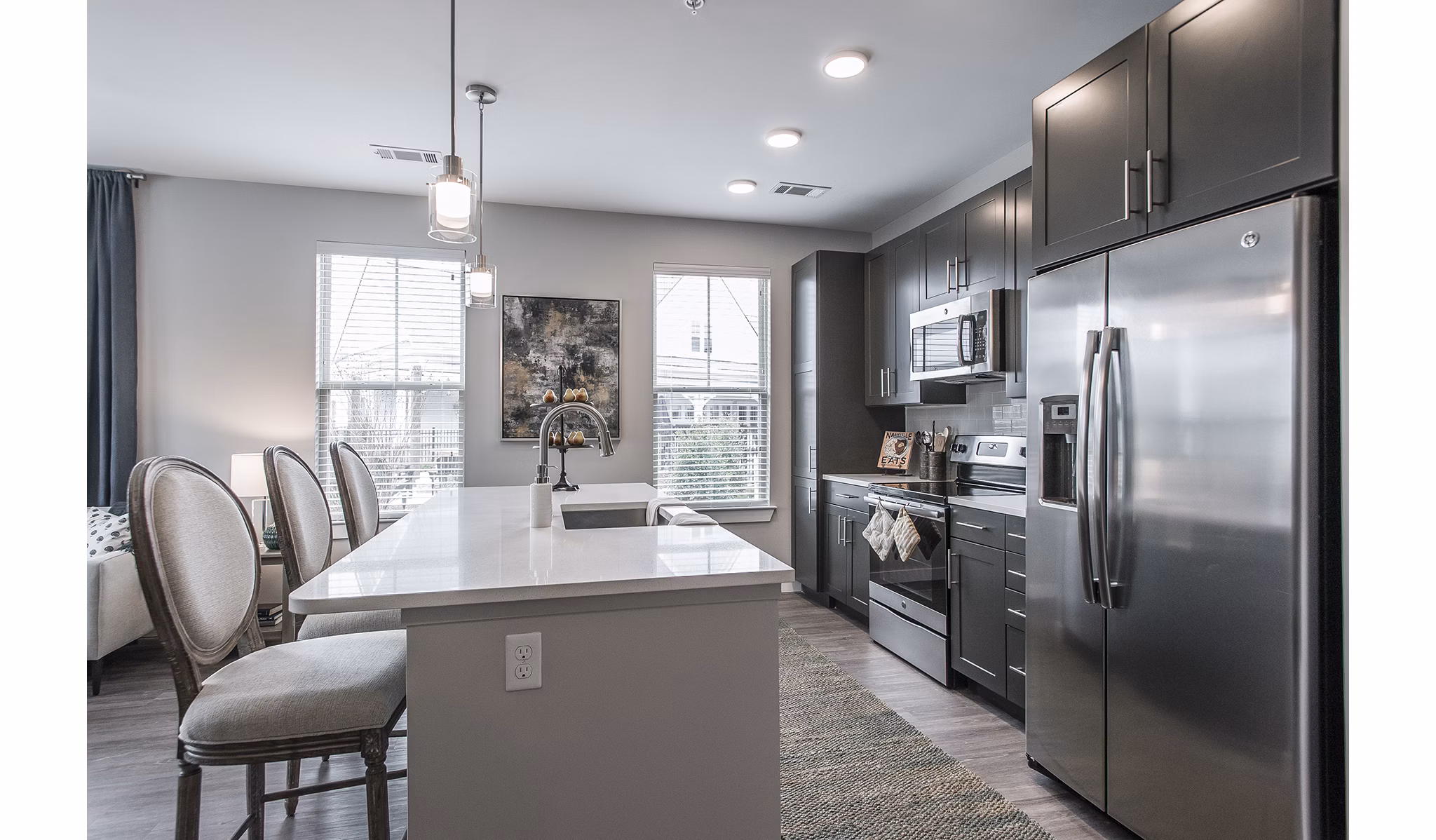 Modern kitchen with stainless steel appliances at Novel Lockwood Glen Apartments in luxury setting