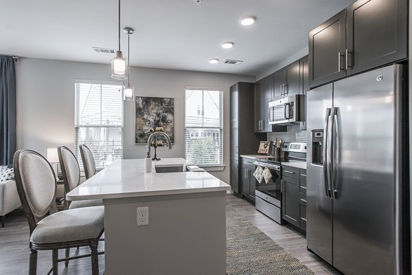 Modern kitchen with stainless steel appliances at Novel Lockwood Glen Apartments in luxury setting