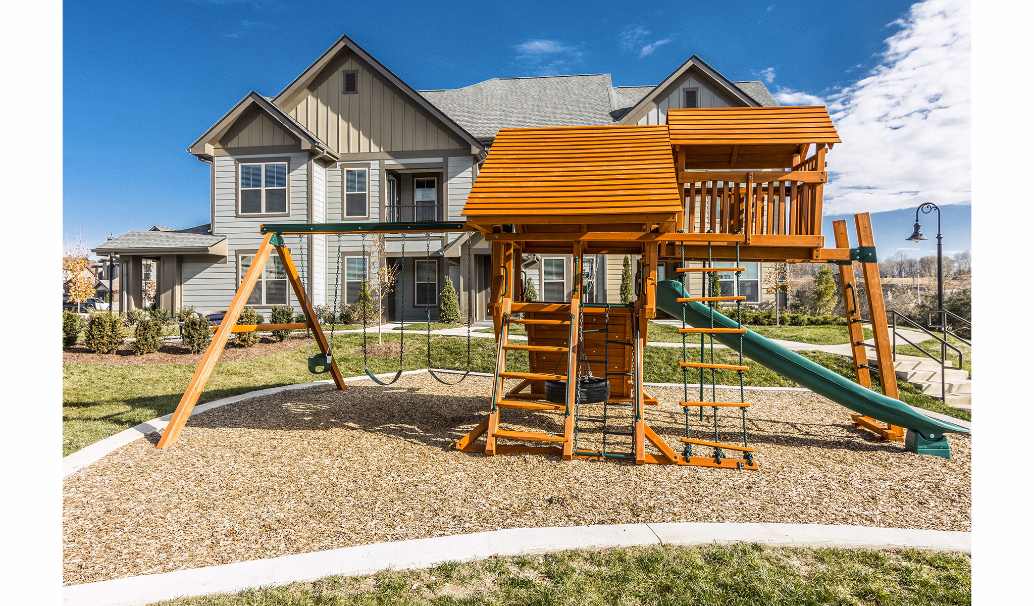 Outdoor playground with modern equipment at Novel Lockwood Glen Apartments, perfect for family-friendly activities