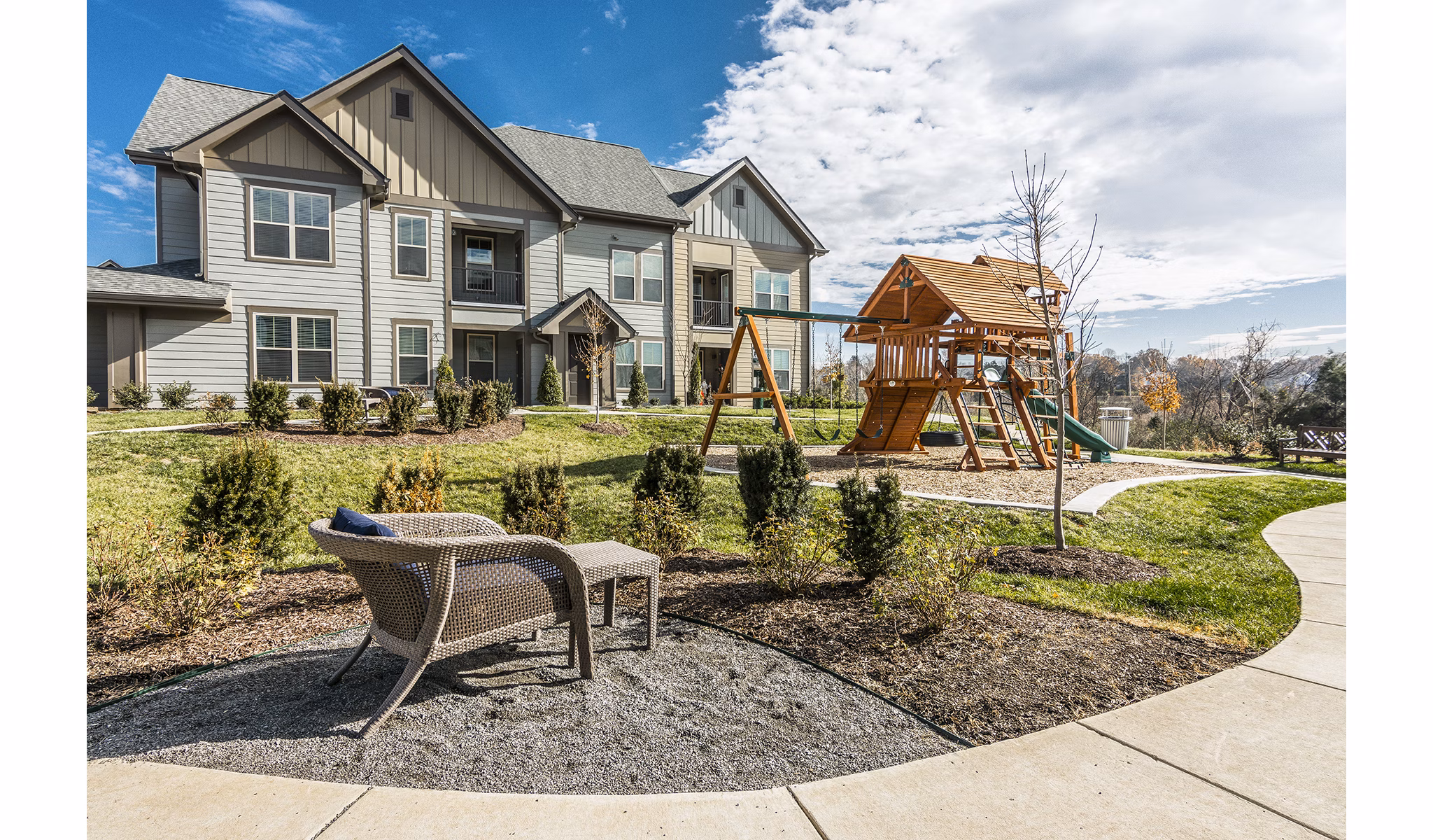 Playground with colorful slides and swings at Novel Lockwood Glen Apartments, offering family-friendly recreational space in a serene environment