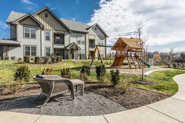 Playground with colorful slides and swings at Novel Lockwood Glen Apartments, offering family-friendly recreational space in a serene environment