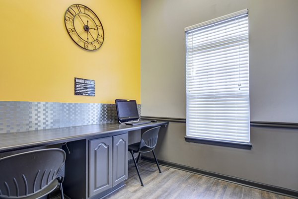 Modern business center with workstations at Summit Pointe Apartments, featuring comfortable seating and high-speed internet access for residents