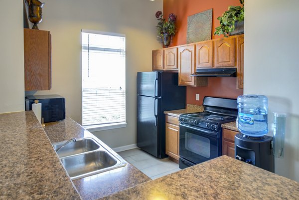 Kitchen featuring modern appliances and granite countertops in Summit Pointe Apartments