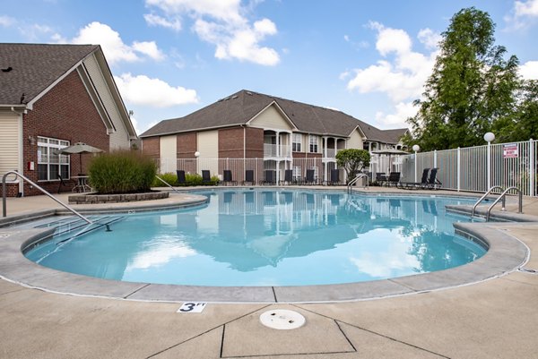Resort-style pool at Summit Pointe Apartments with sun loungers and landscaped gardens