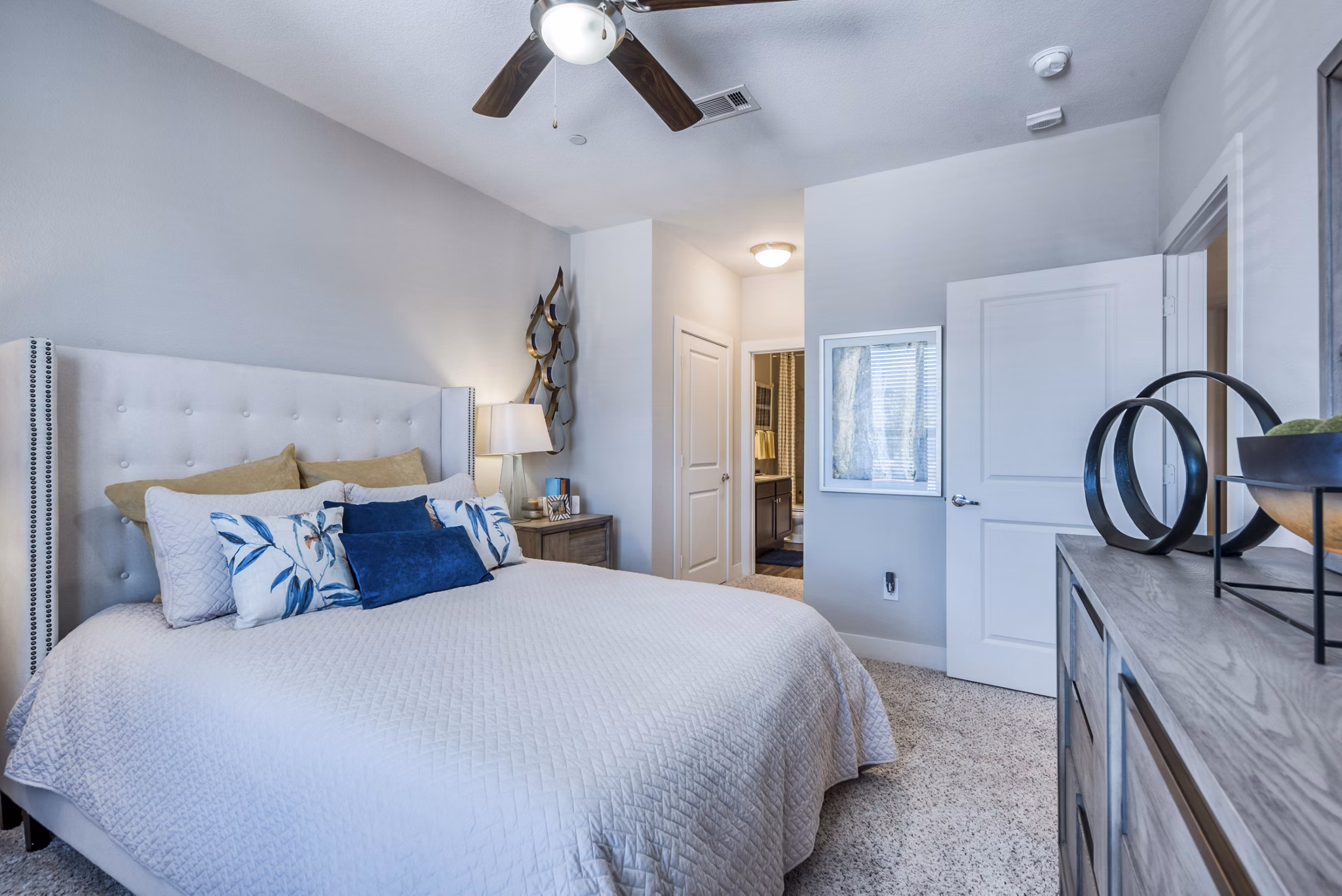 Elegant bedroom with plush bedding and natural light at Lakeview Villas Apartments