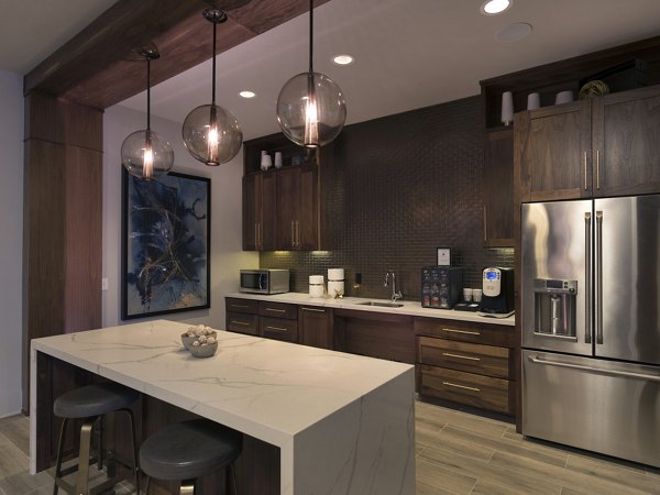 Clubhouse kitchen featuring modern appliances and island seating at Lakeview Villas Apartments