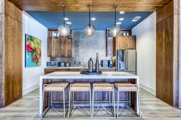 Modern clubhouse kitchen featuring stainless steel appliances and granite countertops at Lakeview Villas Apartments