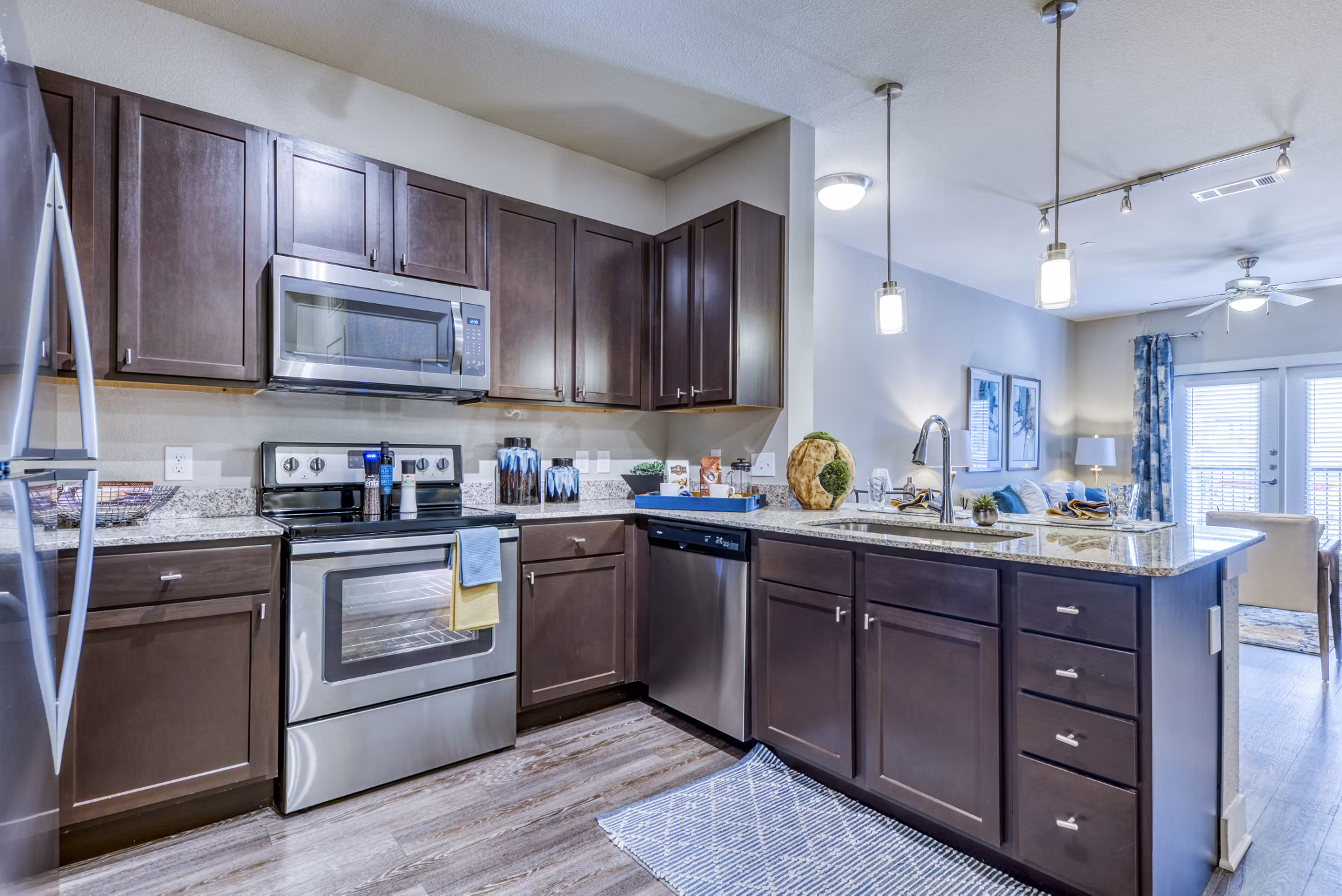 Modern kitchen featuring stainless steel appliances and granite countertops at Lakeview Villas Apartments