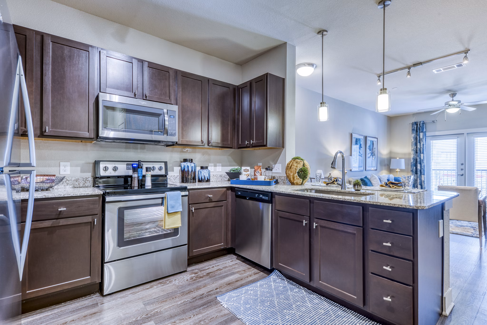 Modern kitchen featuring stainless steel appliances and granite countertops at Lakeview Villas Apartments