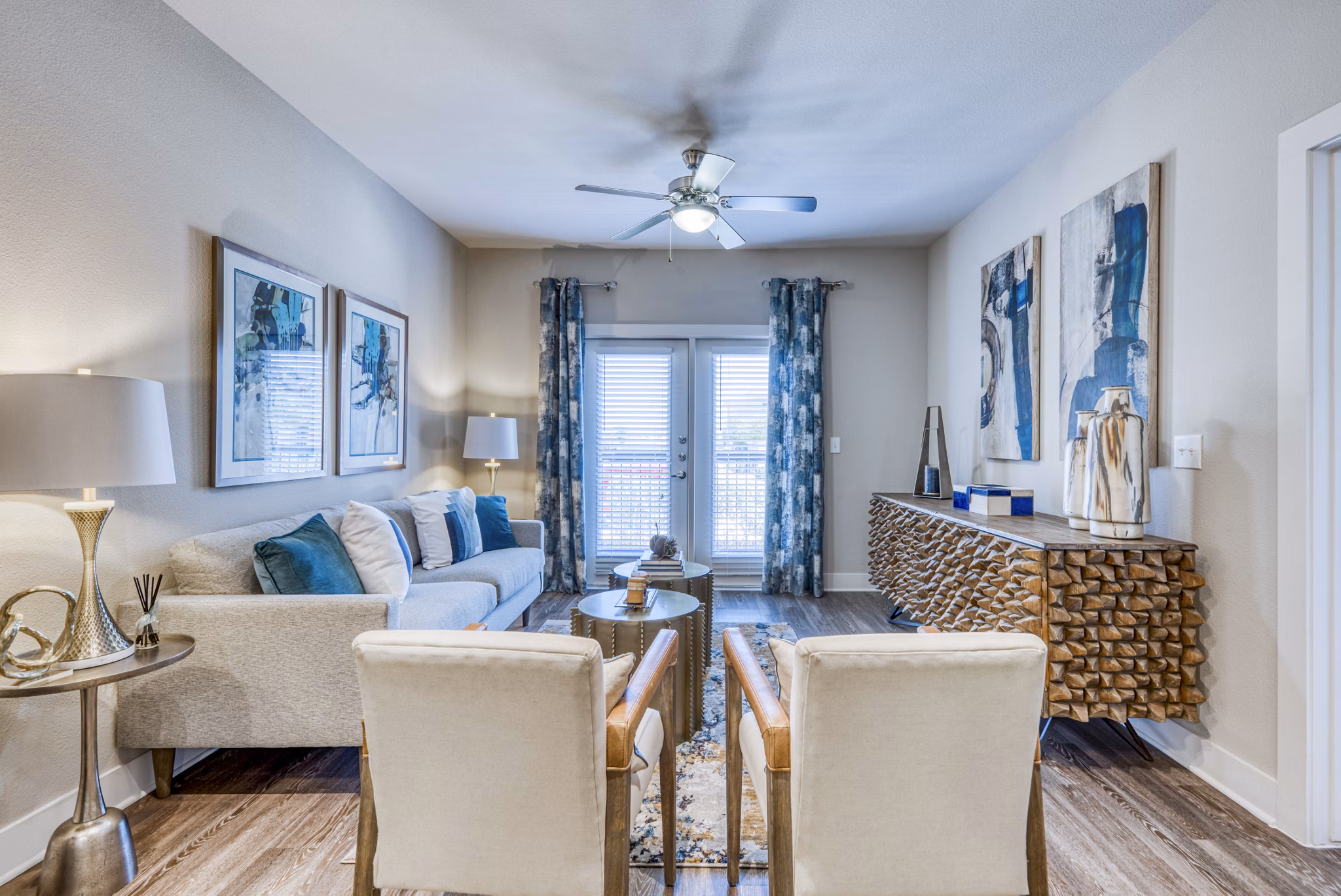Spacious living room with modern decor in Lakeview Villas Apartments abutting serene lake views, ideal for luxury apartment living experiences