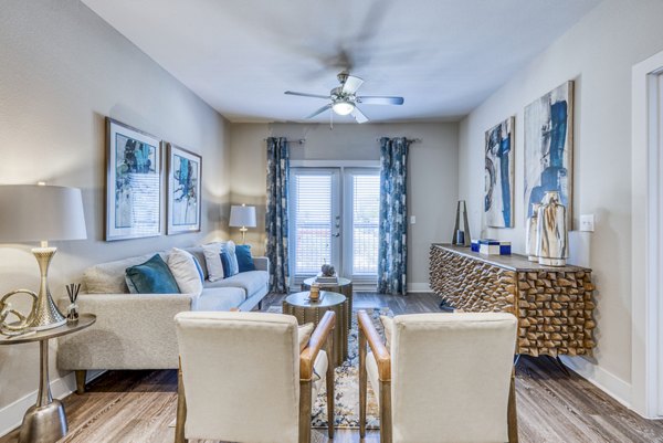 Spacious living room with modern decor in Lakeview Villas Apartments abutting serene lake views, ideal for luxury apartment living experiences