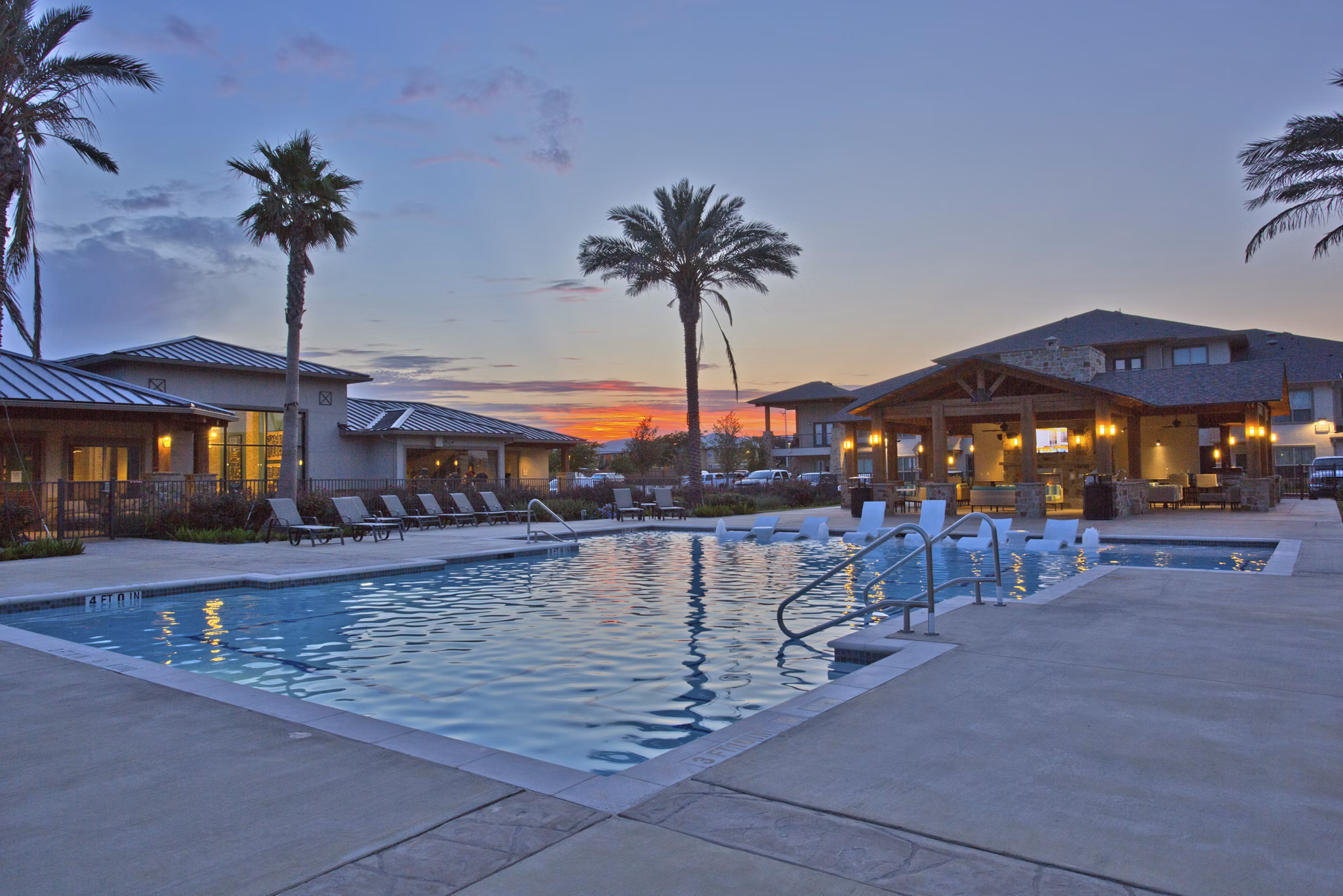 Modern pool area with lush landscaping at Lakeview Villas Apartments