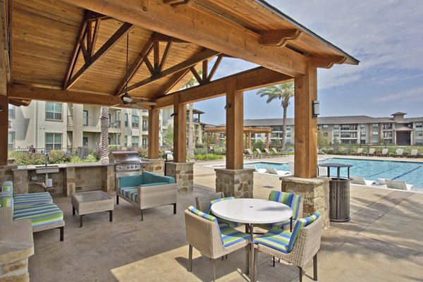 Outdoor grill area with modern seating at Lakeview Villas Apartments