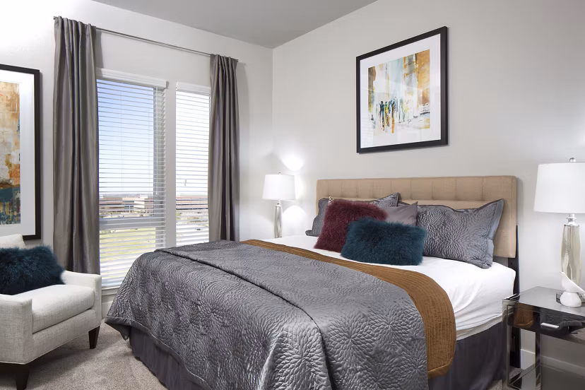 Comfortable bedroom with modern furnishings at The Glenn Apartments, Greystar luxury apartments