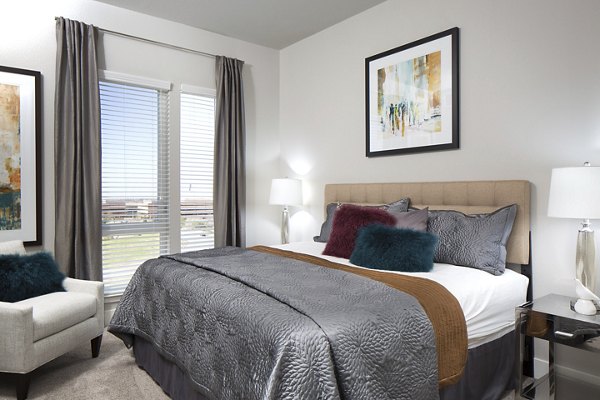 Comfortable bedroom with modern furnishings at The Glenn Apartments, Greystar luxury apartments