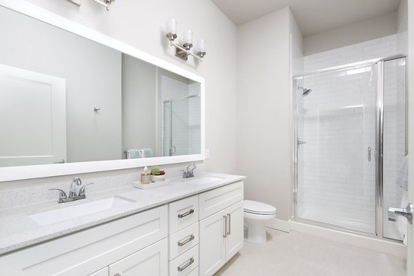 The Glenn Apartments: Modern bathroom with sleek fixtures in luxury Greystar property