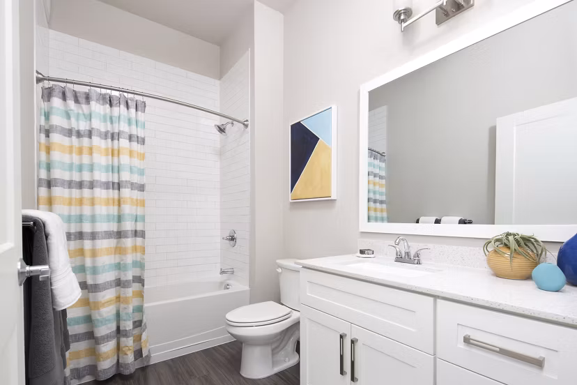 Bathroom with modern fixtures and marble countertops at The Glenn Apartments, luxury living by Greystar