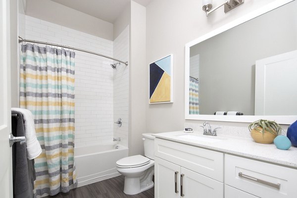 Bathroom with modern fixtures and marble countertops at The Glenn Apartments, luxury living by Greystar