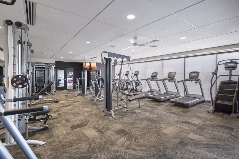 Modern fitness center featuring state-of-the-art equipment at The Glenn Apartments