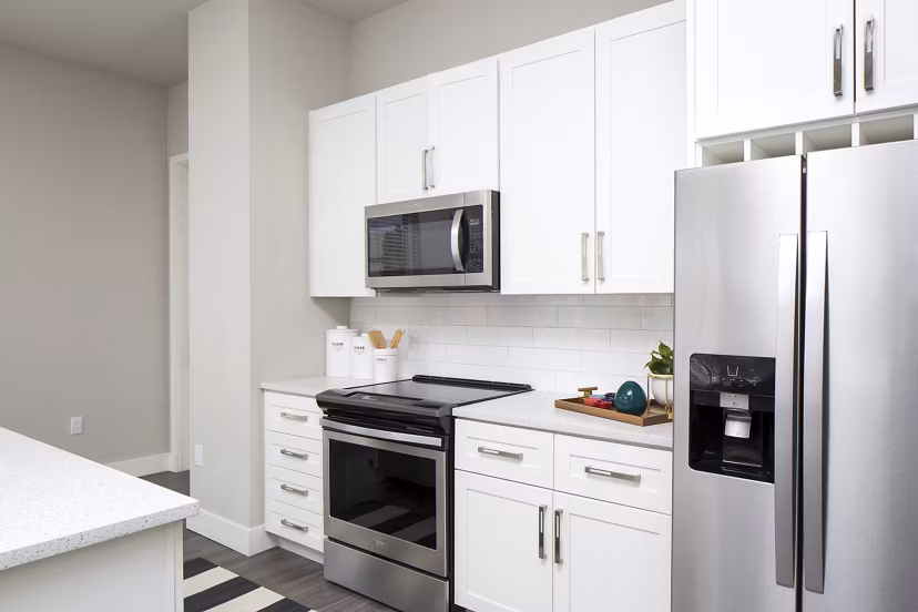 Modern kitchen with sleek countertops and stainless steel appliances at The Glenn Apartments