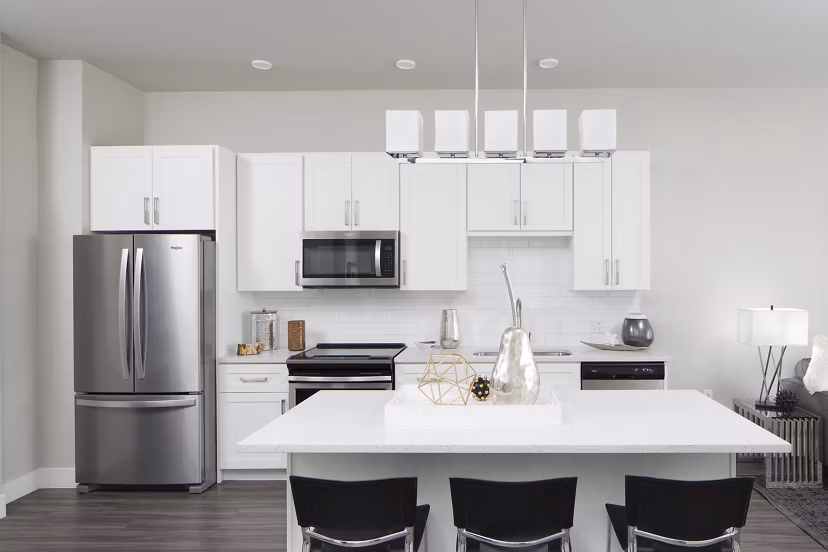 Modern kitchen with stainless steel appliances at The Glenn Apartments