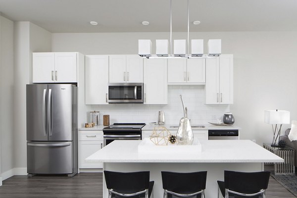 Modern kitchen with stainless steel appliances at The Glenn Apartments