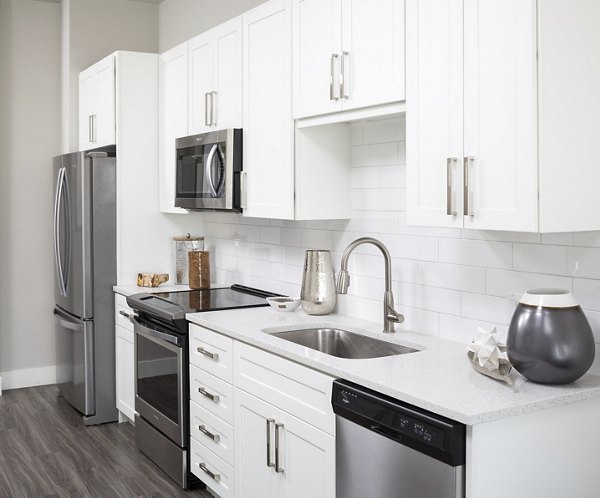 Modern kitchen with stainless steel appliances at The Glenn Apartments