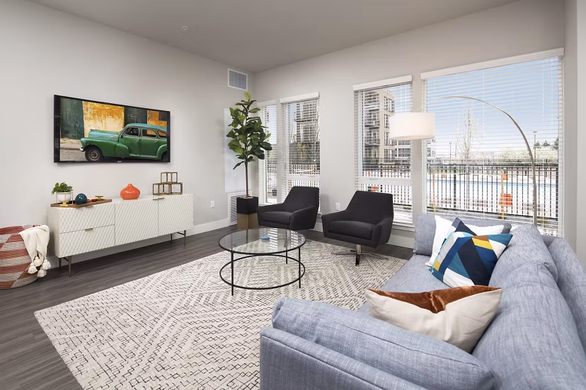 Spacious living room featuring modern design and large windows at The Glenn Apartments, luxury homes by Greystar