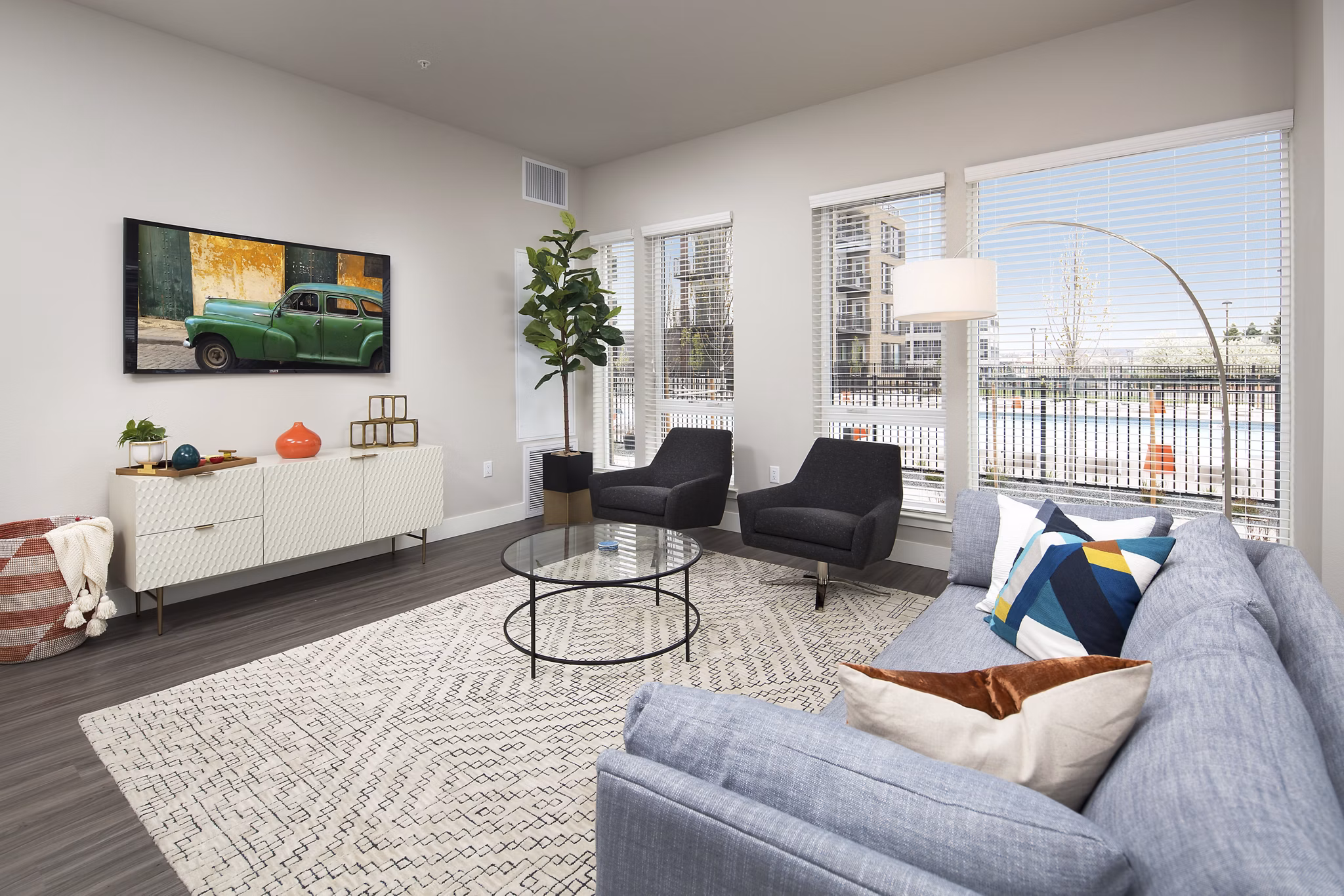 Spacious living room featuring modern design and large windows at The Glenn Apartments, luxury homes by Greystar