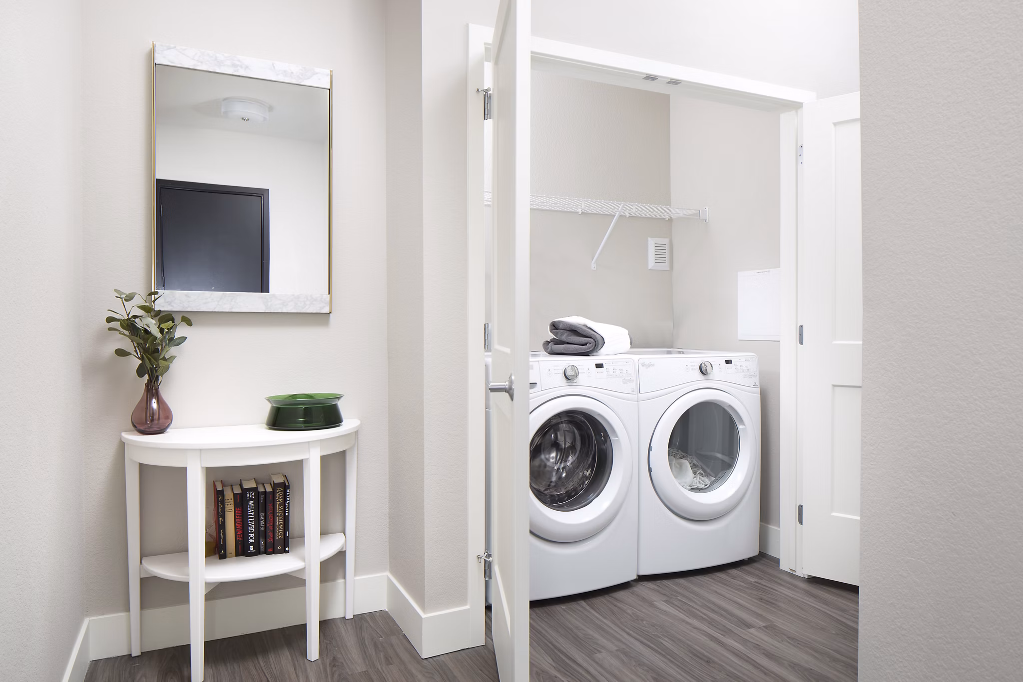 Laundry room with modern washer and dryer units at The Glenn Apartments, a luxury Greystar community