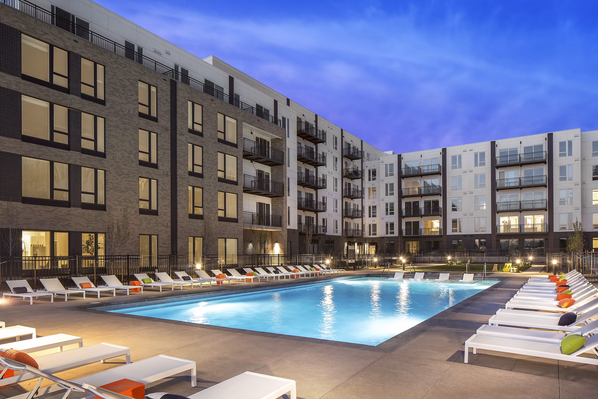 The Glenn Apartments: Luxury pool with sun loungers and shaded areas for relaxation