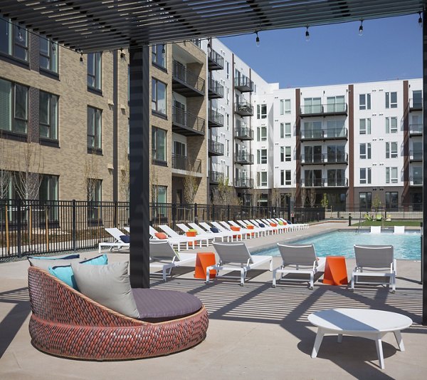 Resort-style pool with sun loungers at The Glenn Apartments
