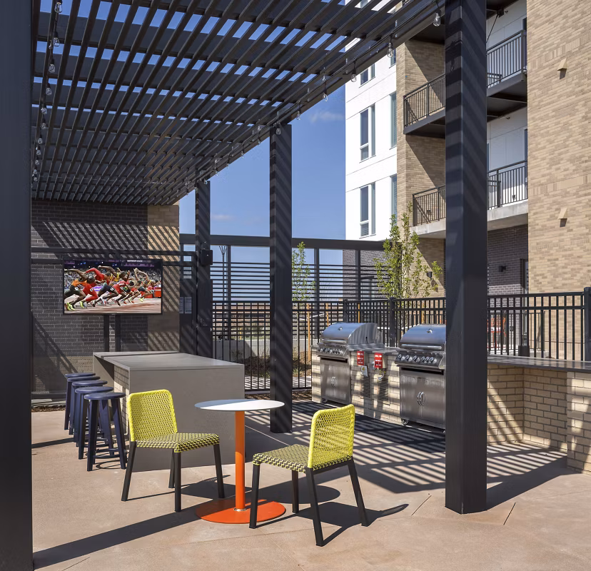Outdoor grilling station with modern appliances at The Glenn Apartments, offering a perfect space for social gatherings and al fresco dining