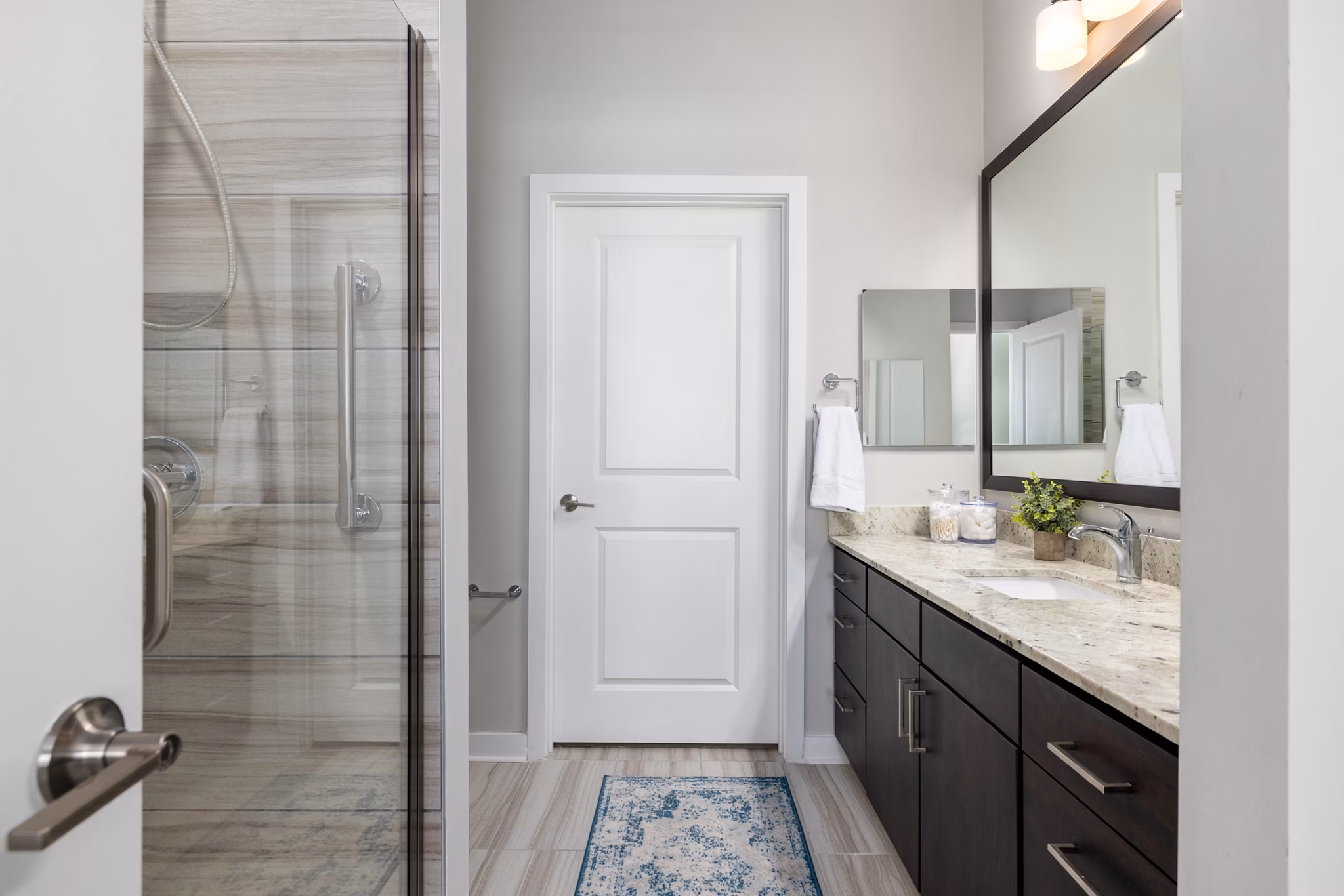 Overture West Ashley: Modern bathroom with sleek fixtures and elegant tiles in luxury apartment