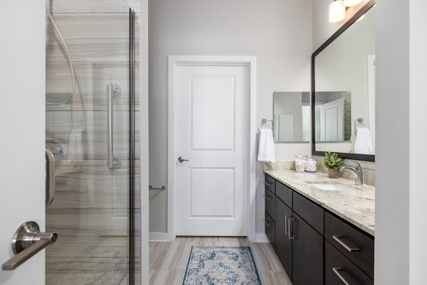 Overture West Ashley: Modern bathroom with sleek fixtures and elegant tiles in luxury apartment