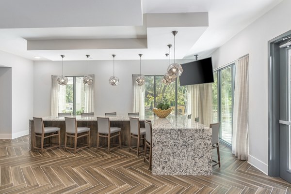 Clubhouse featuring modern design and cozy seating at Overture West Ashley Apartments, ideal for social gatherings and community events