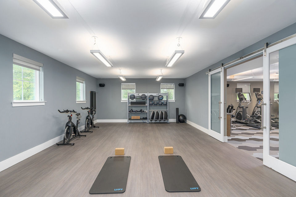 Yoga/spin studio with state-of-the-art equipment at Overture West Ashley Apartments, designed for an active lifestyle