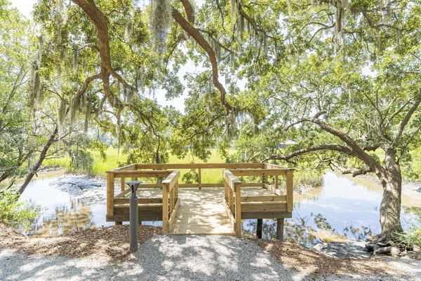 Courtyard with lush gardens at Overture West Ashley Apartments, a luxury Greystar community