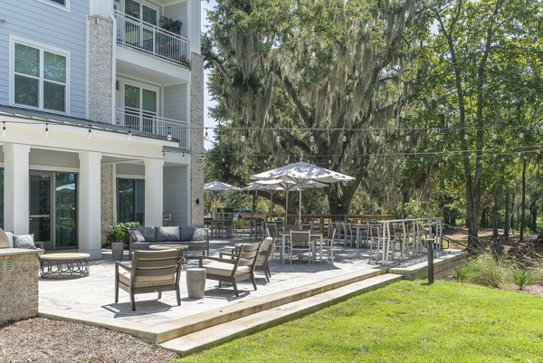 Elegant patio with stylish seating at Overture West Ashley Apartments, perfect for relaxing and socializing in a luxurious setting