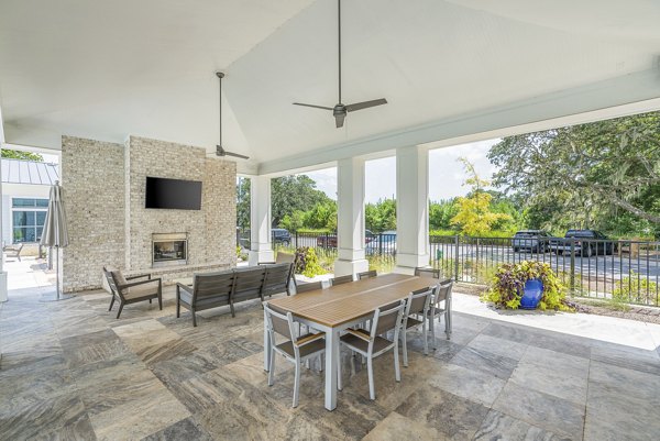 Patio area with modern seating and lush greenery at Overture West Ashley Apartments