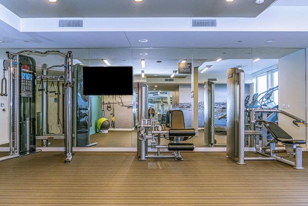 Fitness center with state-of-the-art equipment at AV8 Apartments, offering a premium exercise experience in a luxurious setting