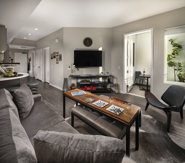 Spacious living room with modern decor and large windows in AV8 Apartments, offering luxury living and comfort