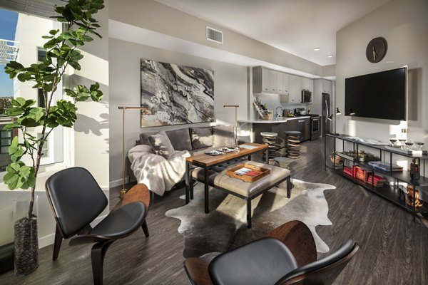 Modern living room featuring sleek furniture and large windows at AV8 Apartments, a luxury property managed by Greystar in San Diego