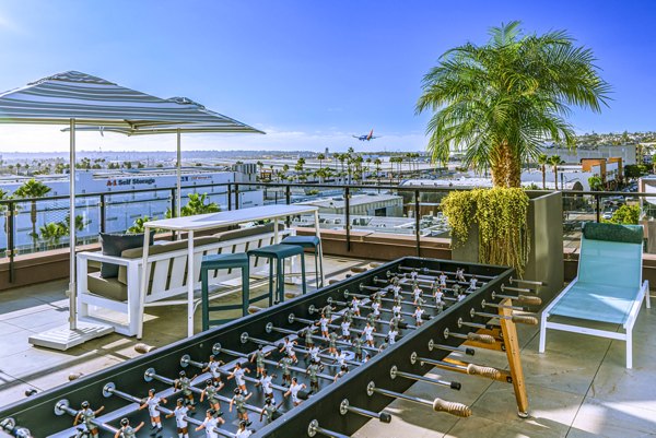 AV8 Apartments: Cozy patio with seating and skyline view