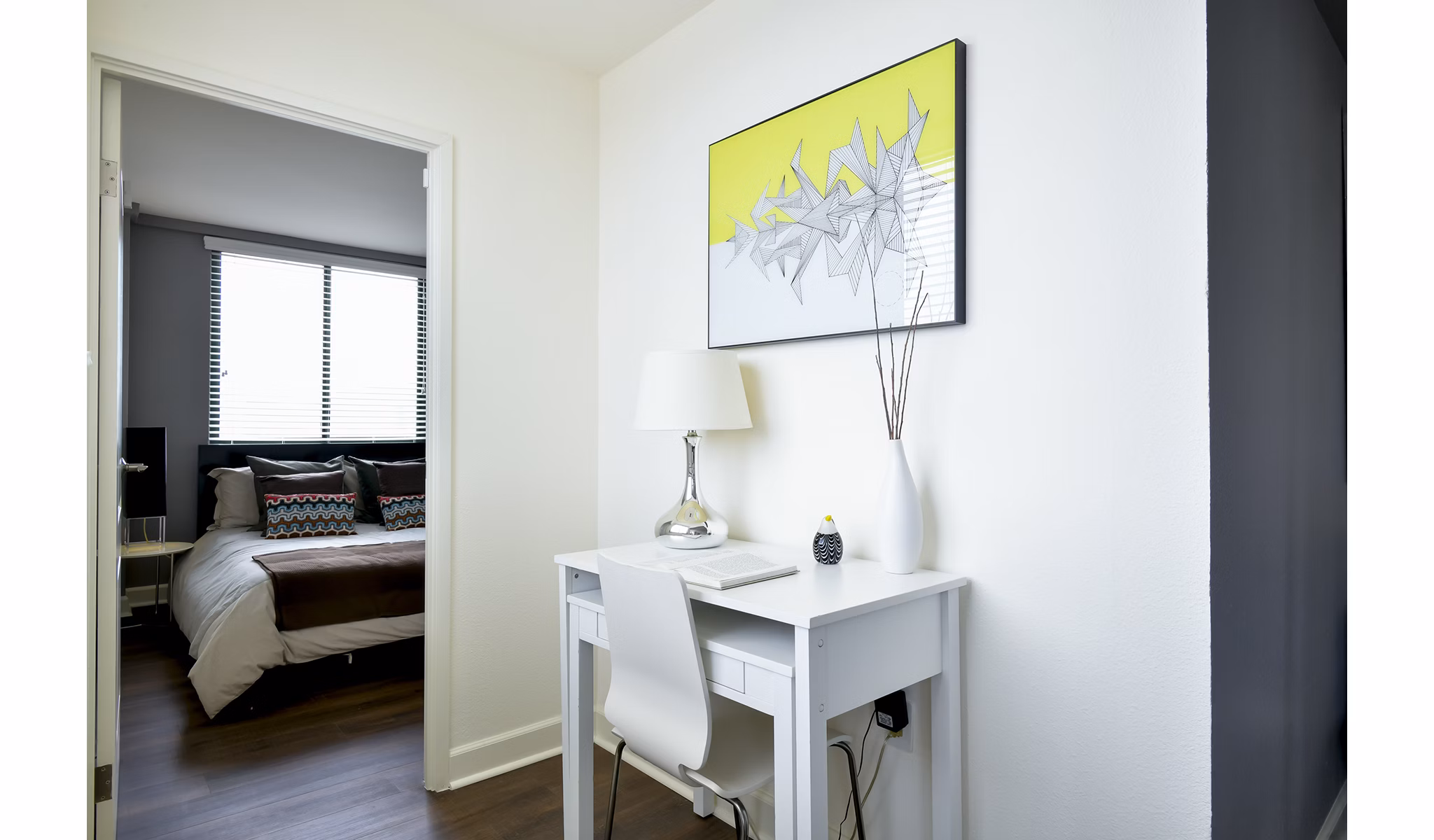 Bedroom with elegant furnishings at The Fillmore Center Apartments, featuring modern design and ample natural light